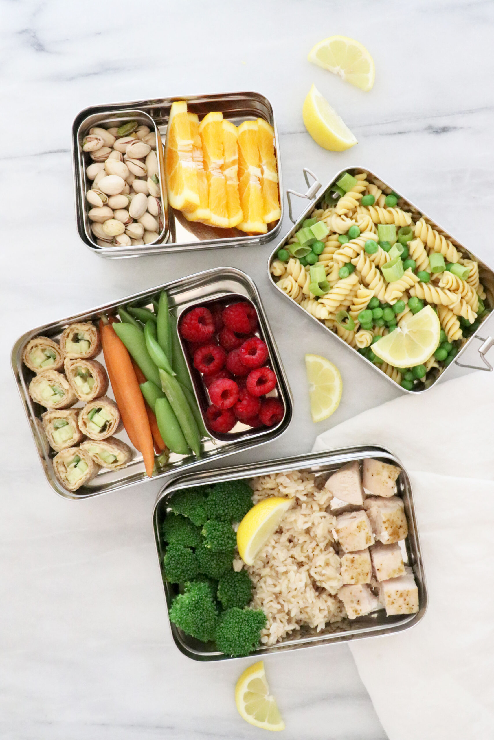 Four lunchboxes filled with different lemon recipes.