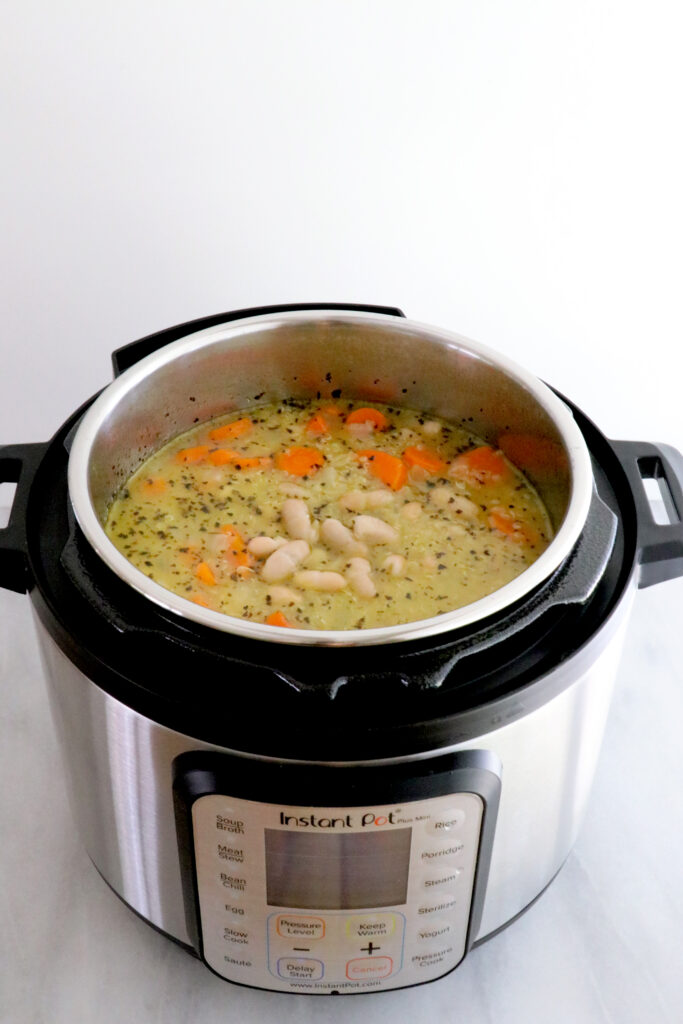 Instant pot with lid off showing quinoa carrot ginger bean soup/