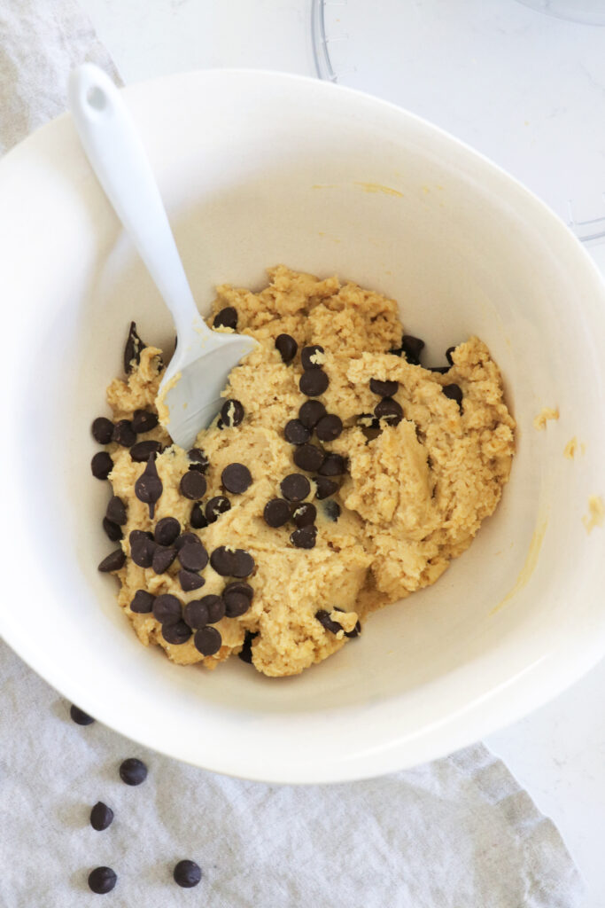 White bowl of gluten-free chickpea chocolate chip cookie dough.