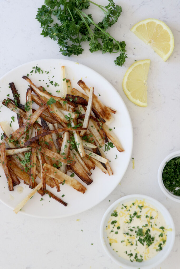Plate with parsnip fries and bowl with lemon aioli on side.