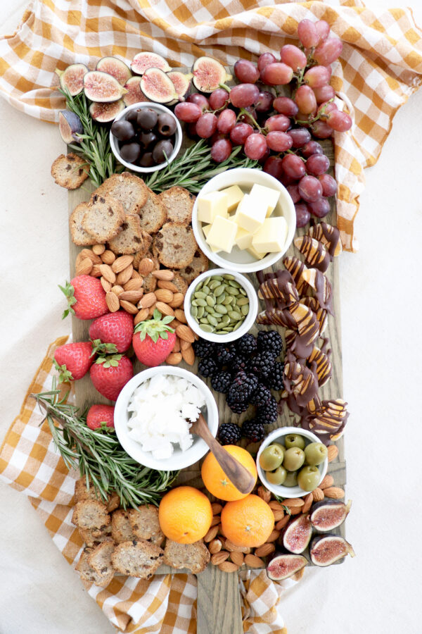 Charcuterie board filled with plant-based snacks.