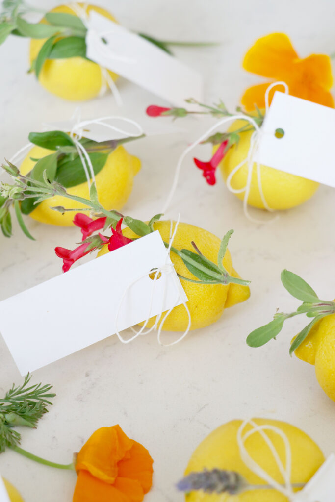 Lemons made with place cards and flowers wrapped in twine.