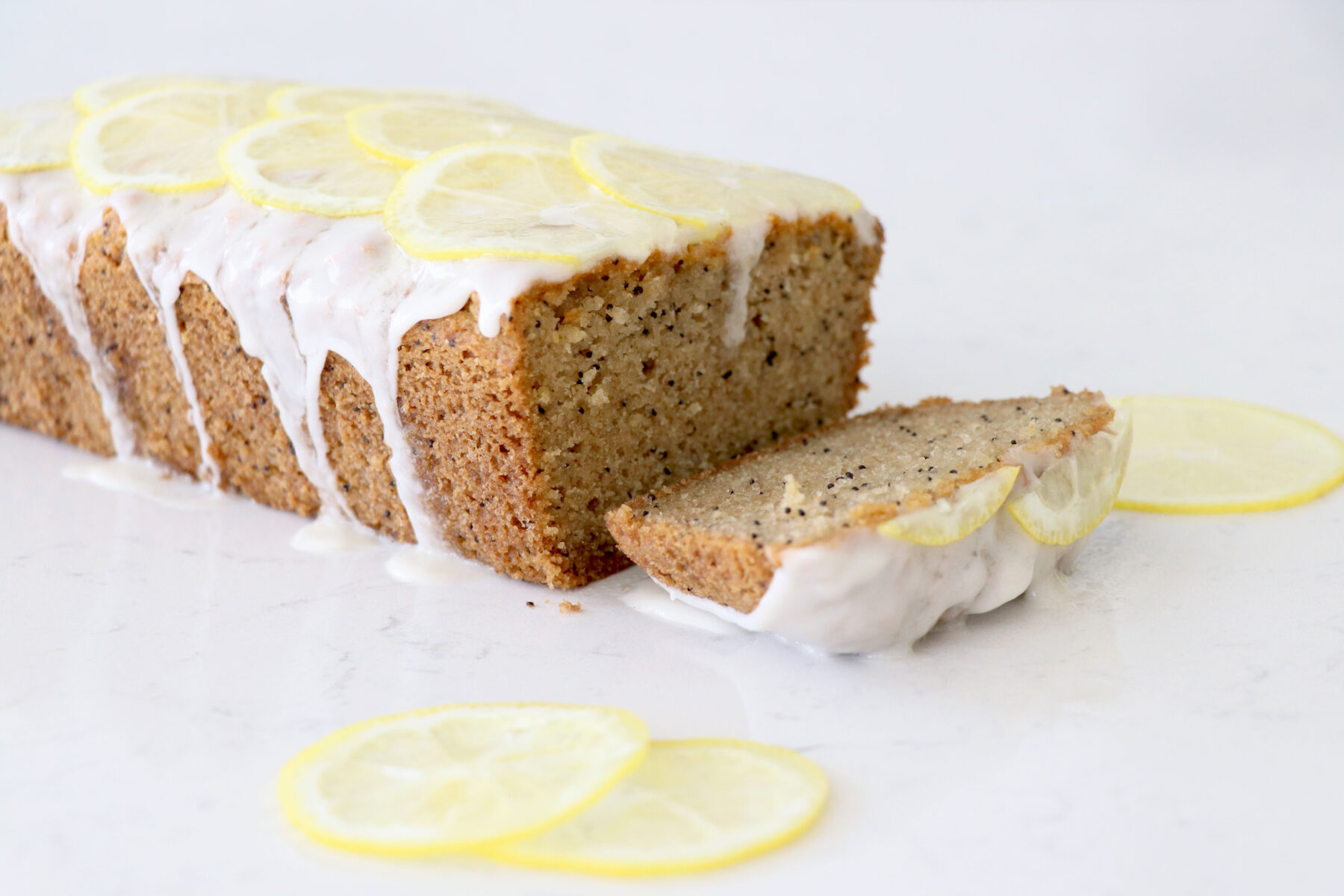 Poppy seed loaf with lemons on top.