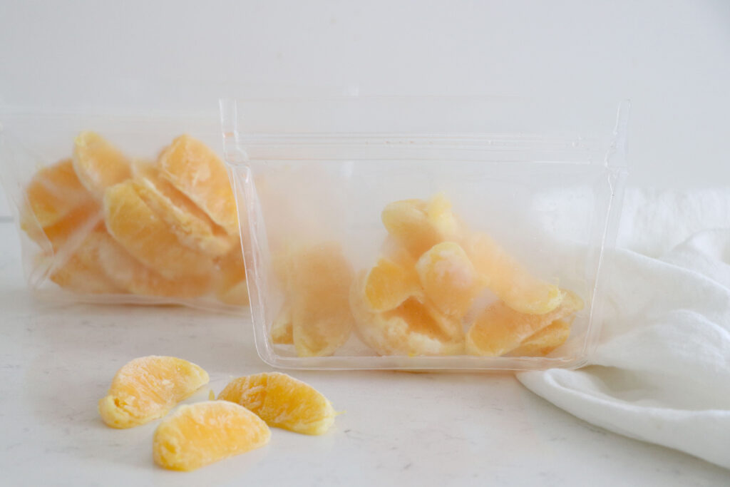 Clear bags with frozen orange slices.