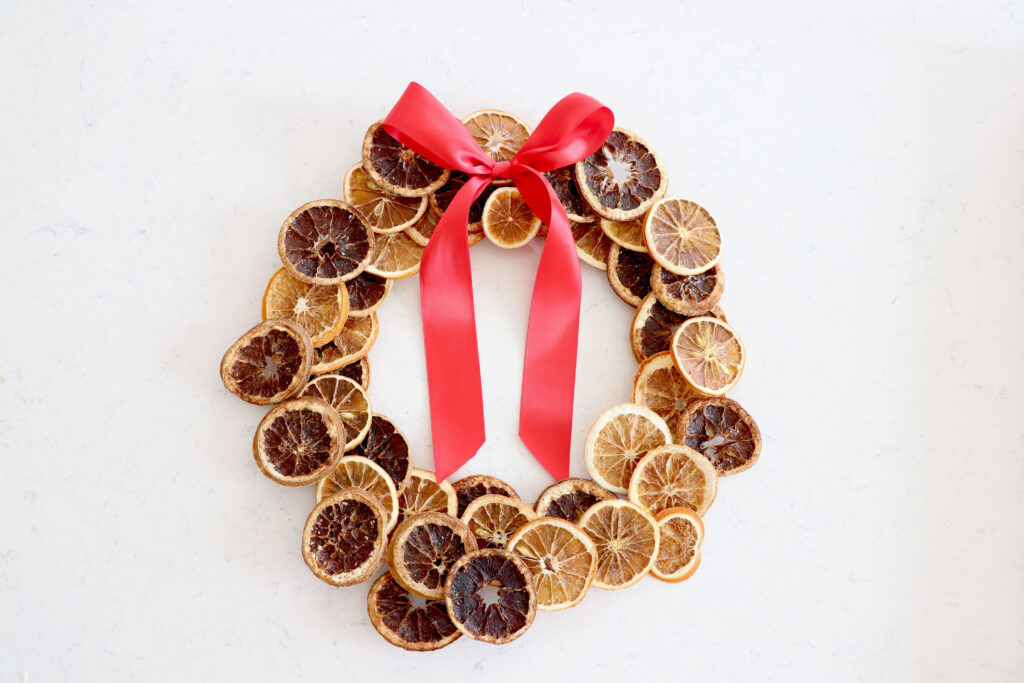 Dried orange holiday wreath on countertop
